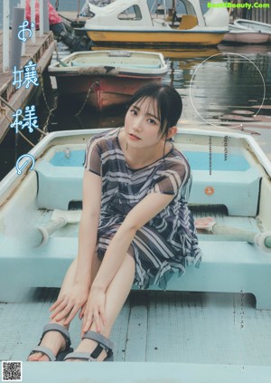A woman with long black hair and a blue dress.