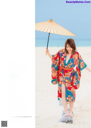 A woman in a red and white kimono laying on a mat.
