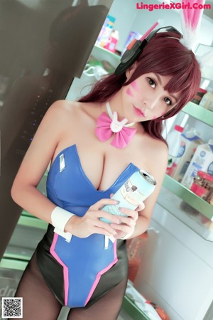 A woman in a blue dress with bunny ears on her head.