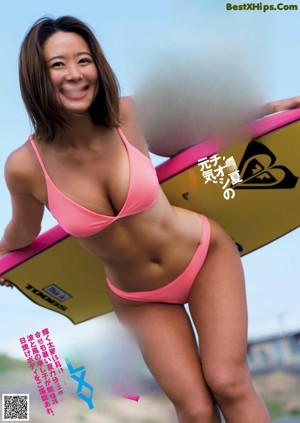 A woman in a bikini laying on a bed.