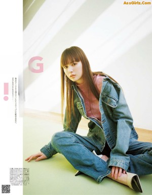 A woman in a white shirt and pink pants crouching on the ground.
