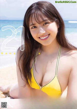 A woman in a bikini posing on a beach.