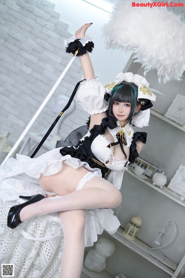 A woman in a maid outfit is posing for a picture.