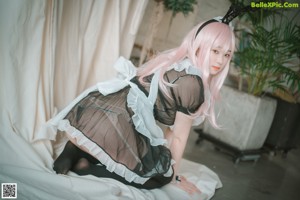 A woman with pink hair wearing a bunny costume.