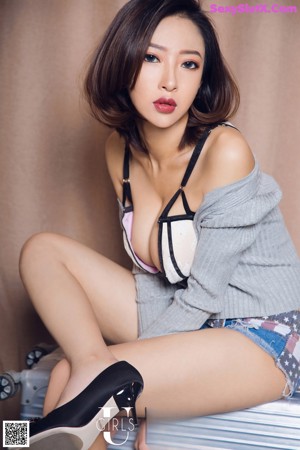 A woman in a black lingerie posing for a picture.