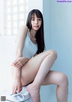 A woman in a black top is posing for a picture.