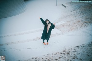 A woman wearing a face mask in the snow.