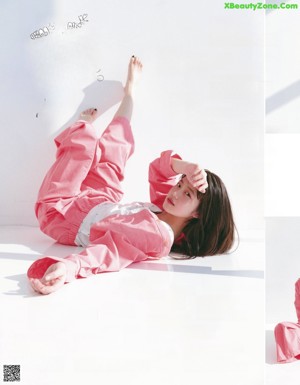 A woman with long brown hair is posing for a magazine.