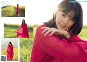 A woman in a pink dress is posing for a picture.