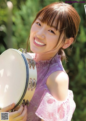 A girl in a pink dress is posing for a picture.