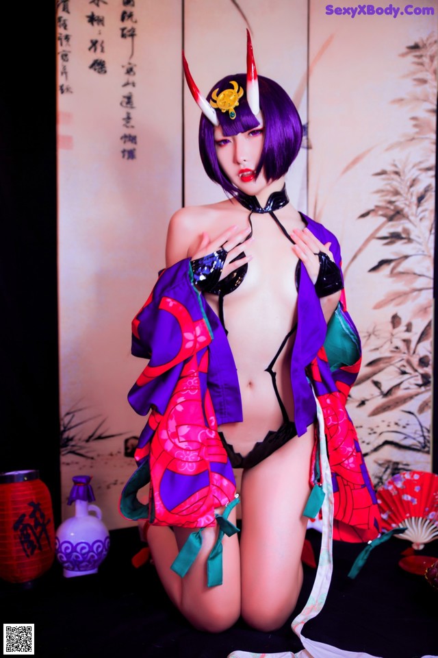 A woman in a kimono is posing for a picture.