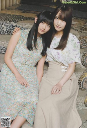 A couple of young women holding hands in a magazine.
