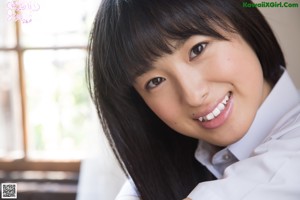 A young woman in a school uniform posing for a picture.