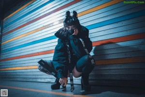 A woman in a black outfit is posing for a picture.