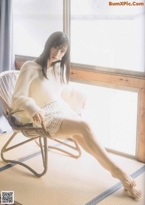 A woman sitting on the floor in a magazine.