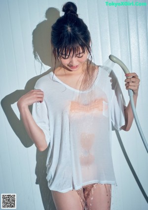 A woman in a white lingerie laying on a bed.